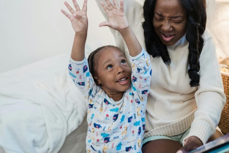 A joyful mother and child developing speech comprehension while reading a book by acting it out.